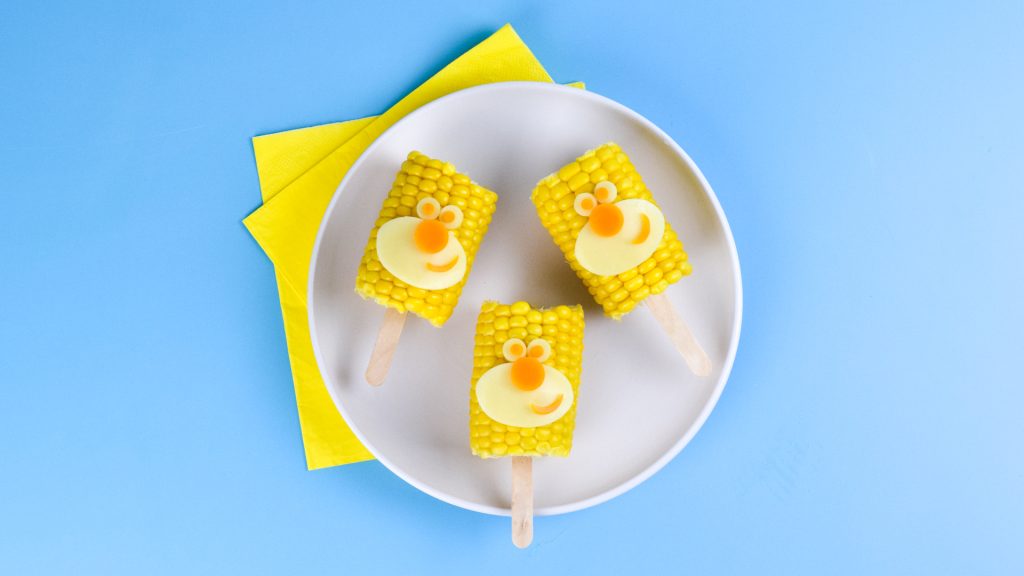 Photograph of three cooked Hey Duggee corn pops.